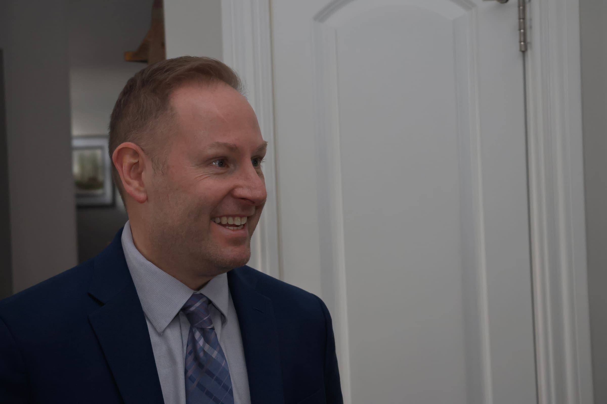 Thomas West smiling during a conversation